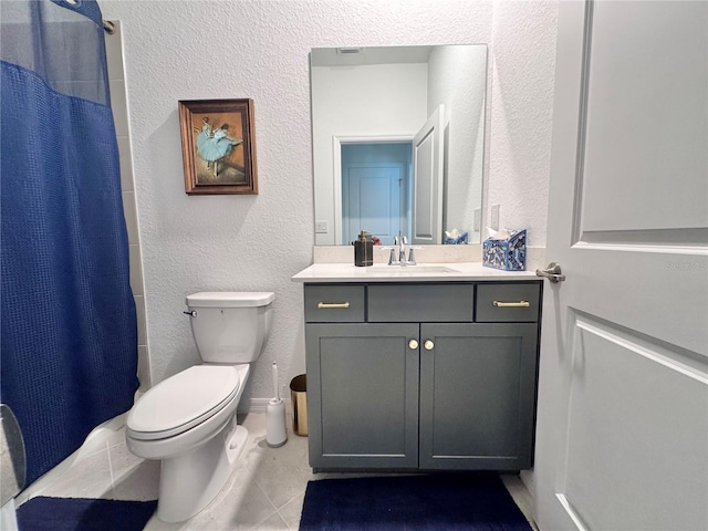 bathroom with vanity, toilet, curtained shower, and tile patterned flooring