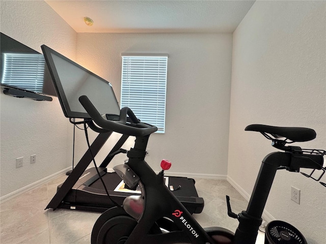 workout room featuring light tile patterned flooring