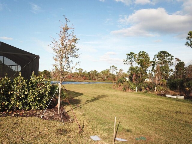 19060 Moscato Ct, Venice, FL 34293 - view of grassy yard featuring a water view and a lanai
