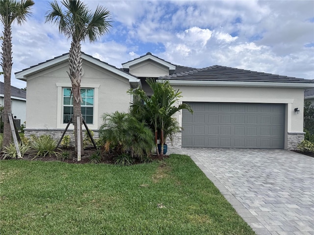 19060 Moscato Ct, Venice, FL 34293 - ranch-style home featuring stucco siding, decorative driveway, stone siding, and a front lawn