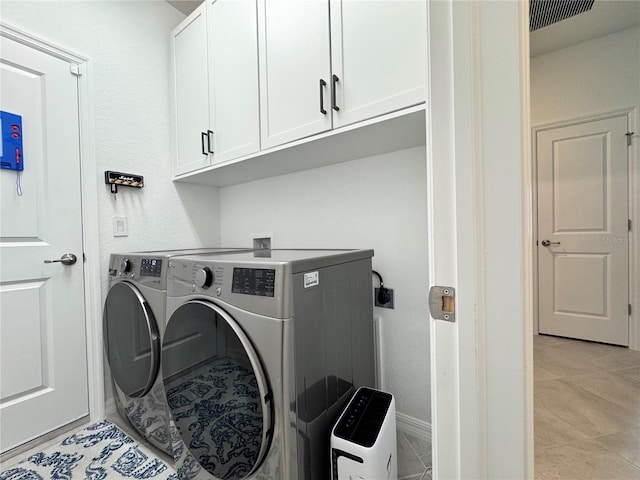 19060 Moscato Ct, Venice, FL 34293 - laundry area with cabinet space, separate washer and dryer, and baseboards