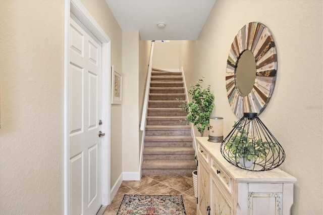 stairway with tile patterned flooring