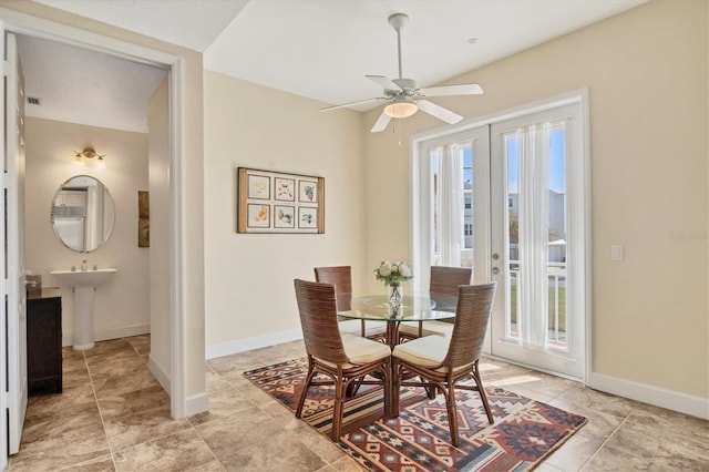 dining room featuring sink, french doors, and ceiling fan