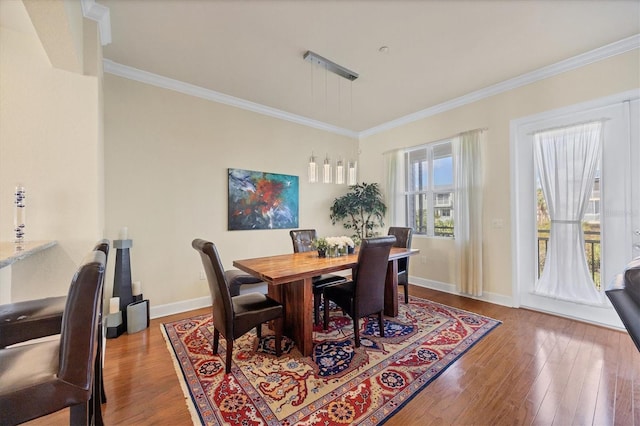 dining room featuring ornamental molding and wood-type flooring