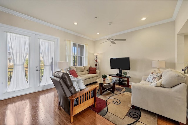 living room with french doors, ornamental molding, wood-type flooring, and ceiling fan