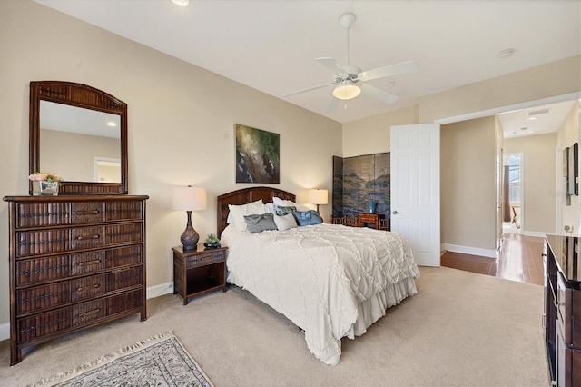 carpeted bedroom with vaulted ceiling and ceiling fan