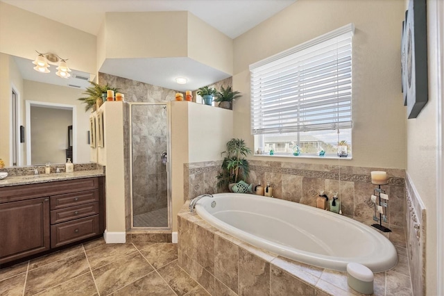 bathroom with vanity and independent shower and bath