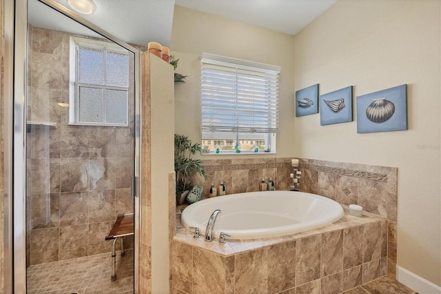 bathroom featuring shower with separate bathtub