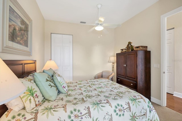 carpeted bedroom featuring ceiling fan and a closet