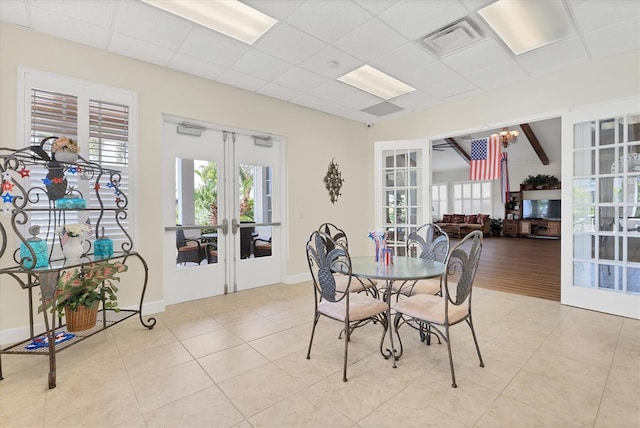 dining room with light tile patterned floors, a wealth of natural light, and french doors