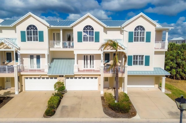 townhome / multi-family property with a garage and a balcony