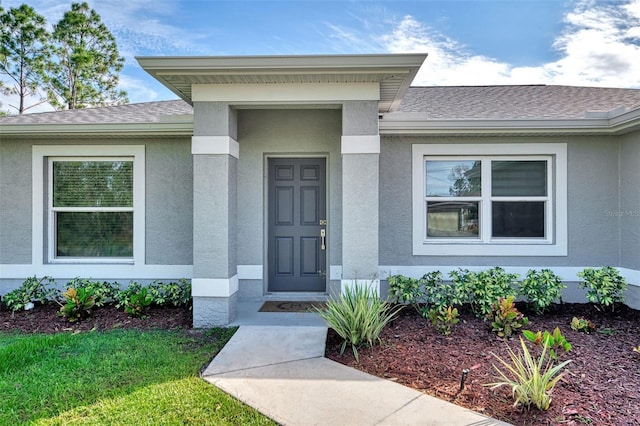 2775 Wyola Ave, North Port, FL 34286 - property entrance featuring stucco siding and roof with shingles