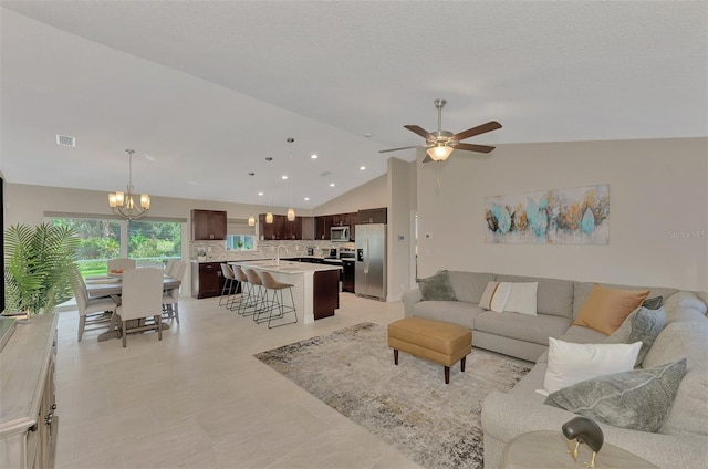 2775 Wyola Ave, North Port, FL 34286 - living room featuring recessed lighting, visible vents, lofted ceiling, and ceiling fan with notable chandelier