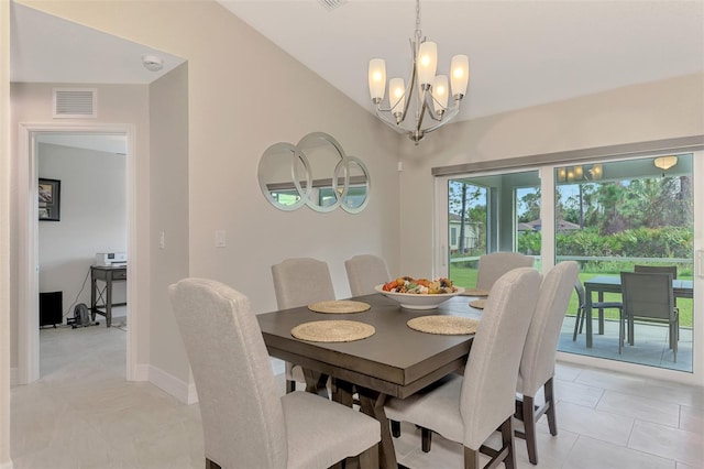 tiled dining space with an inviting chandelier and lofted ceiling