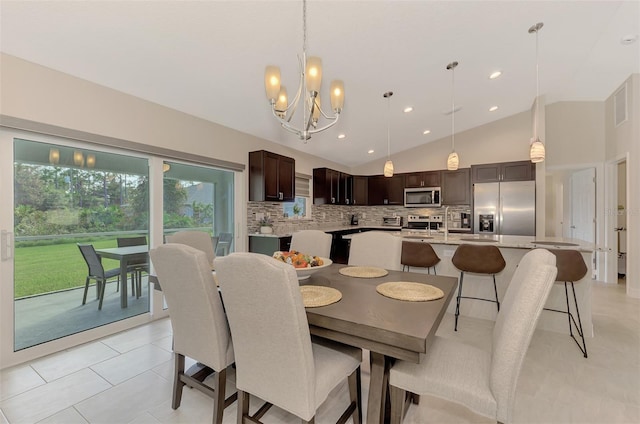 tiled dining space with a notable chandelier and high vaulted ceiling