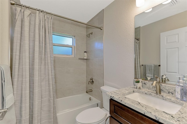 full bathroom with vanity, shower / bath combo with shower curtain, and toilet