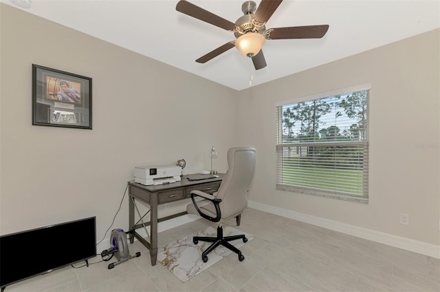 tiled office featuring ceiling fan