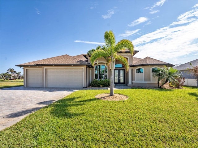 view of front of property with a garage and a front lawn