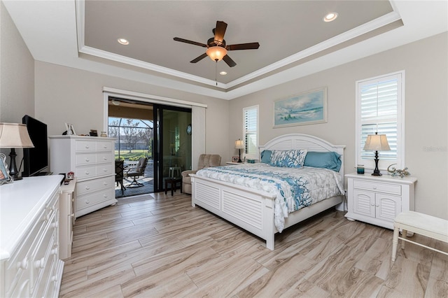 bedroom featuring crown molding, a tray ceiling, access to outside, and ceiling fan