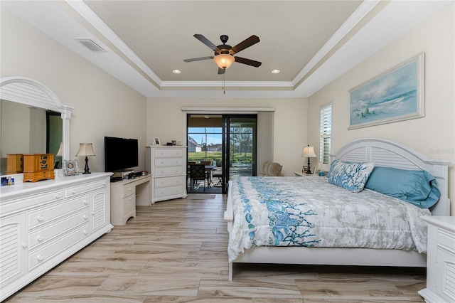 bedroom with ornamental molding, a raised ceiling, access to exterior, and ceiling fan