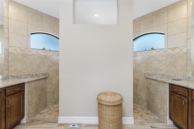 bathroom featuring vanity and a tile shower