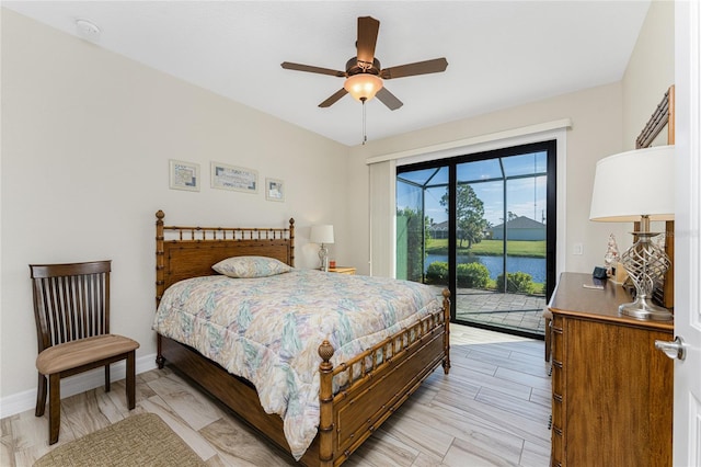 bedroom featuring access to exterior, light wood-type flooring, a water view, and ceiling fan