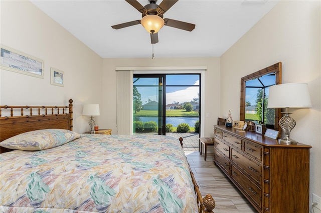 bedroom with a water view, ceiling fan, light wood-type flooring, and access to exterior