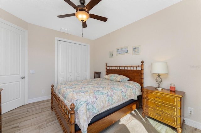 bedroom with light hardwood / wood-style floors, a closet, and ceiling fan