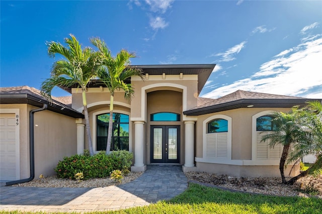 property entrance featuring french doors and a garage