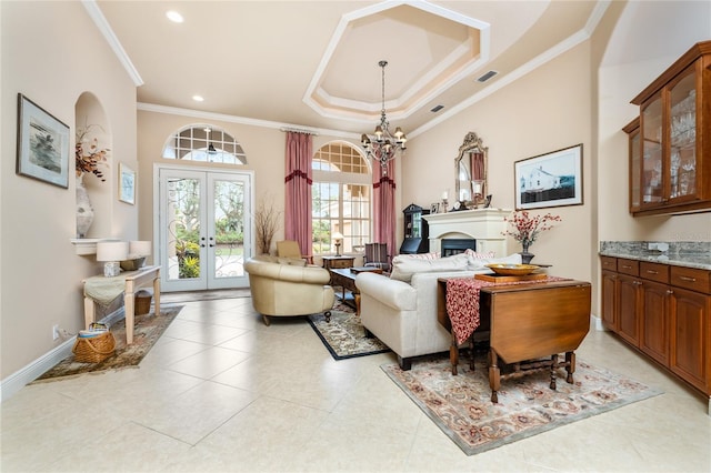 tiled living room with a raised ceiling, french doors, a notable chandelier, and crown molding