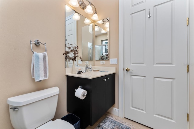 bathroom with tile patterned flooring, vanity, and toilet