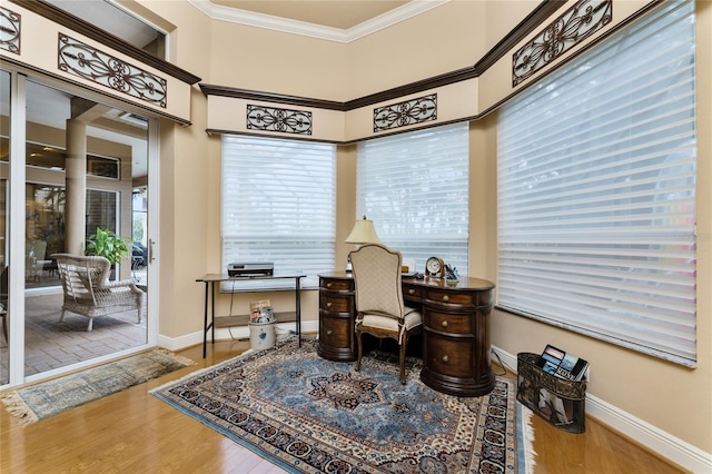 home office featuring a high ceiling, wood-type flooring, and crown molding