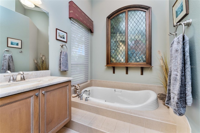 bathroom with vanity and tiled tub