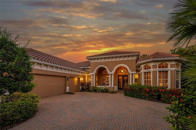 mediterranean / spanish-style home featuring a garage