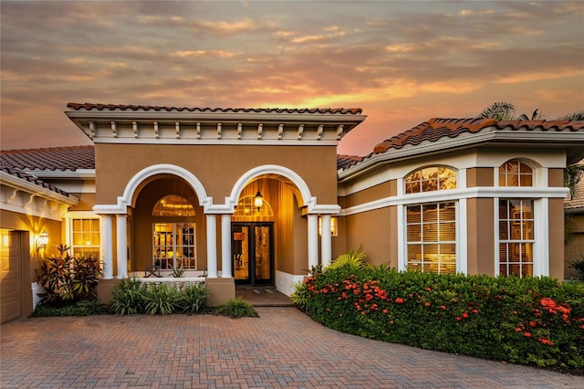 exterior entry at dusk with a garage