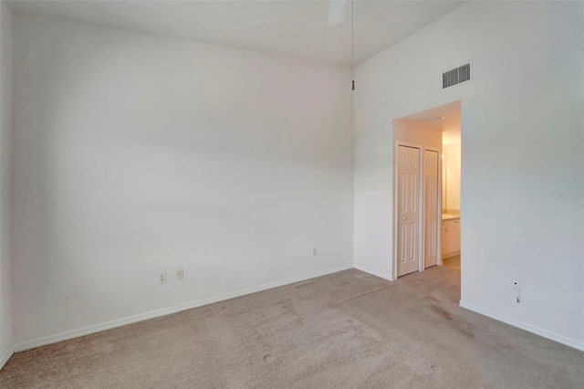 unfurnished room featuring light carpet