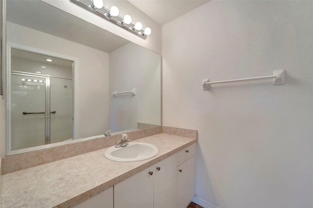 bathroom featuring vanity and an enclosed shower