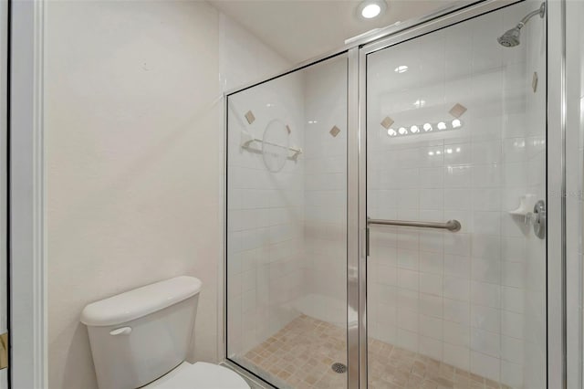 bathroom featuring toilet and walk in shower