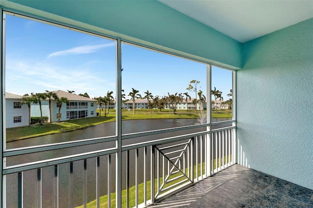 unfurnished sunroom with a water view