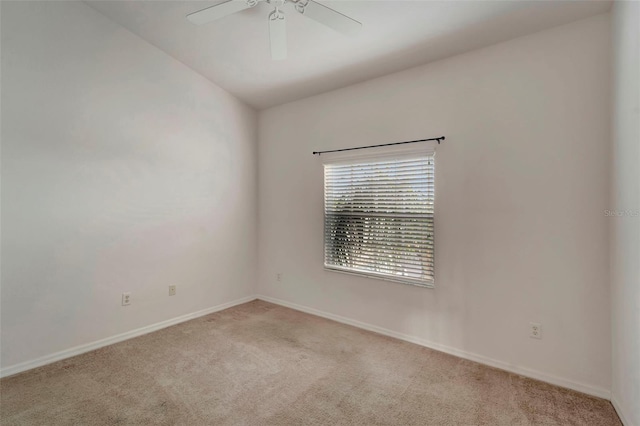 carpeted spare room with lofted ceiling and ceiling fan