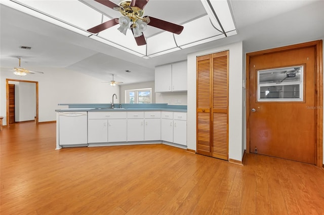 kitchen with white cabinetry, light wood-type flooring, vaulted ceiling, dishwasher, and sink