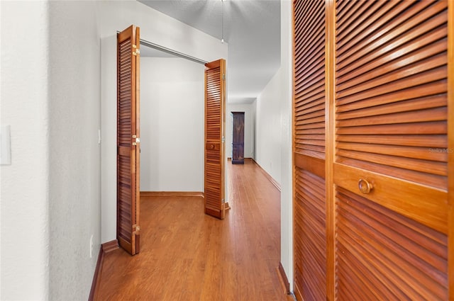 hall with light hardwood / wood-style flooring