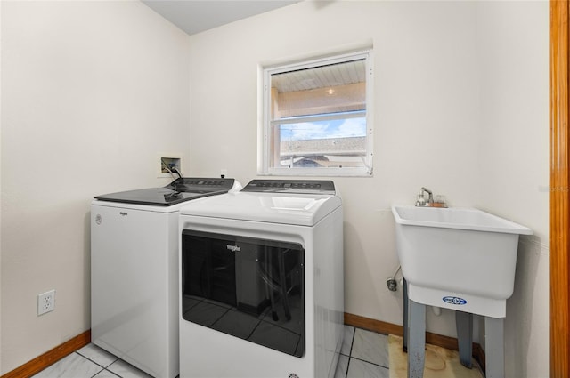 laundry room with sink, washer and clothes dryer, and light tile patterned floors