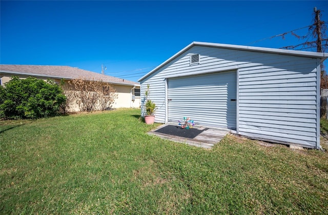 exterior space featuring a lawn and a garage