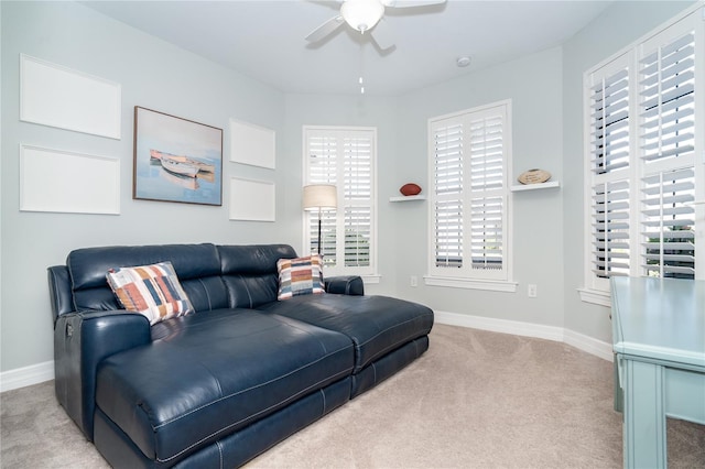 carpeted living room with ceiling fan