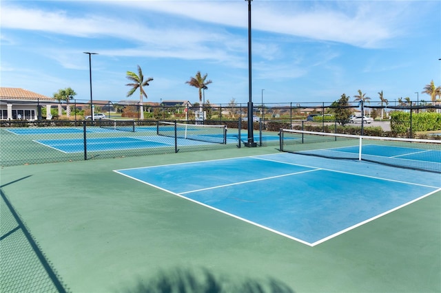 view of tennis court with basketball hoop