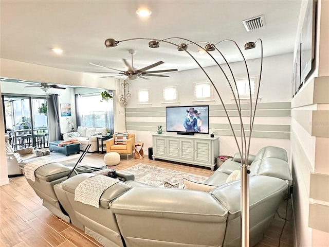 living room with ceiling fan and light hardwood / wood-style floors