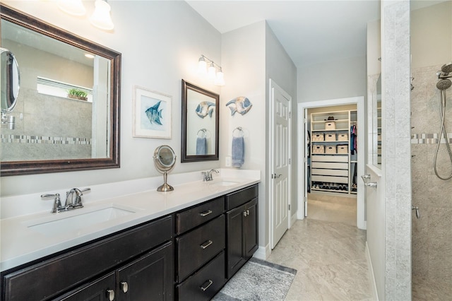 bathroom featuring vanity and a tile shower