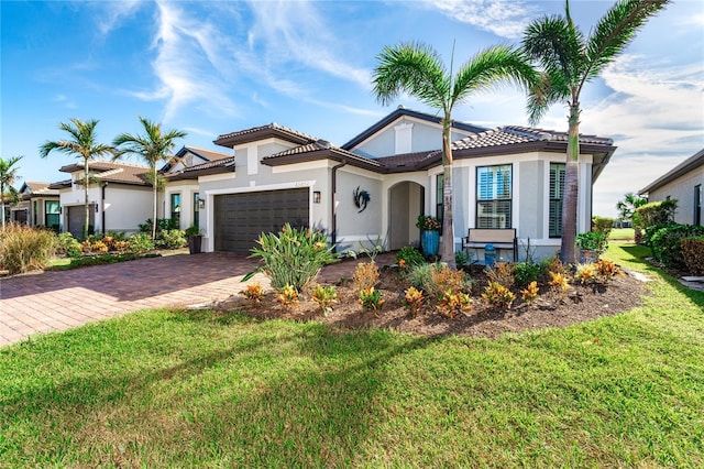 mediterranean / spanish-style house with a garage and a front yard