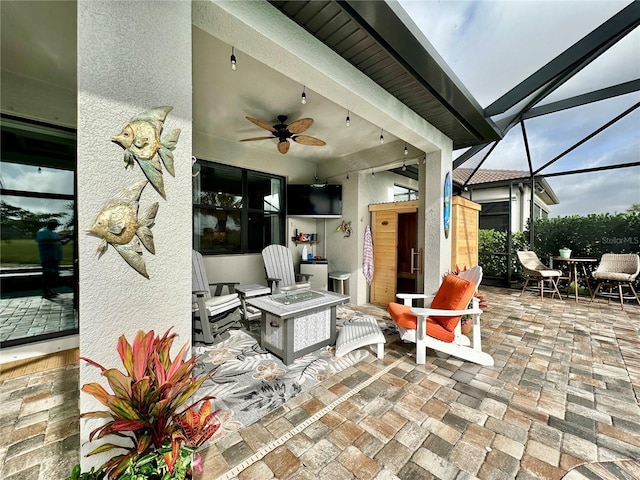 view of patio / terrace with a lanai and a ceiling fan